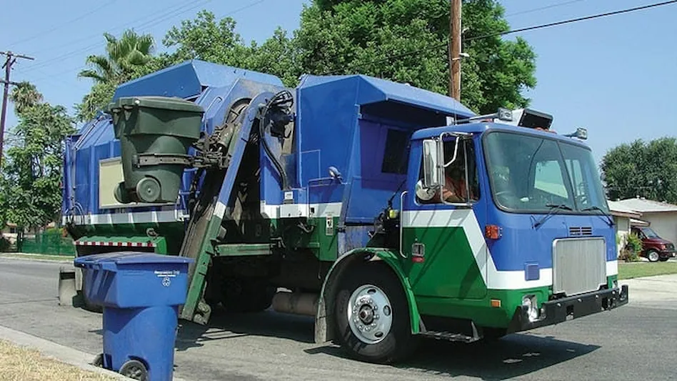 Recycling truck collects bins