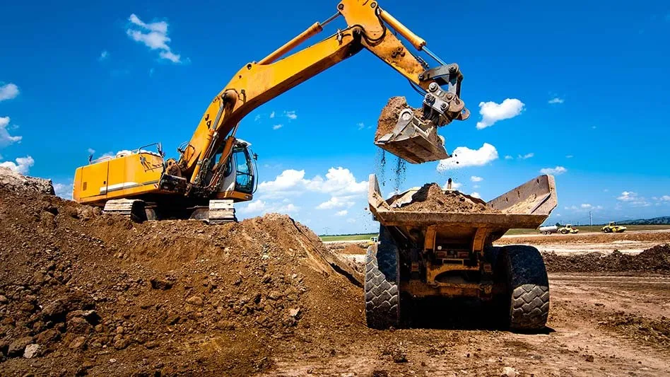 Excavator putting soil in truck