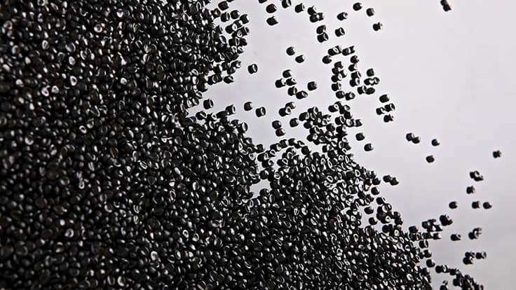 black plastic pellets on gray background