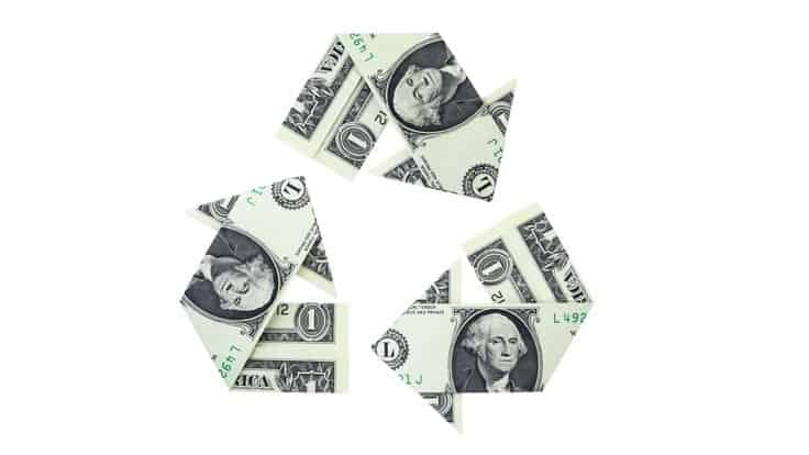 dollar bills arranged in recycling symbol