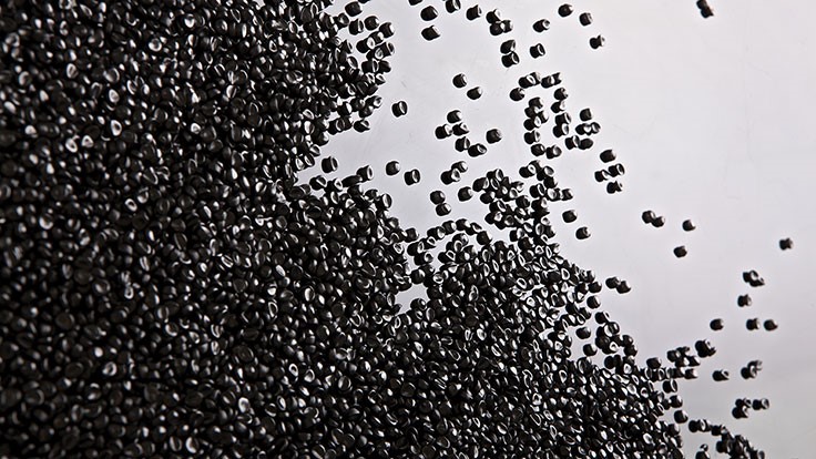 black plastic pellets on white background