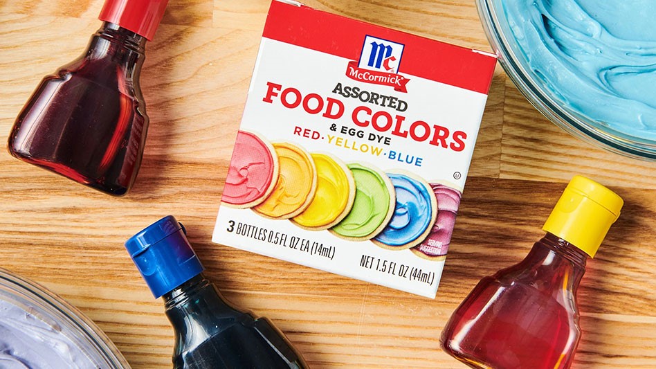 bottles of food coloring on wooden table