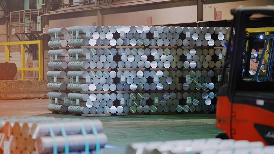 stacks of aluminum billets with a forklift in the forefront
