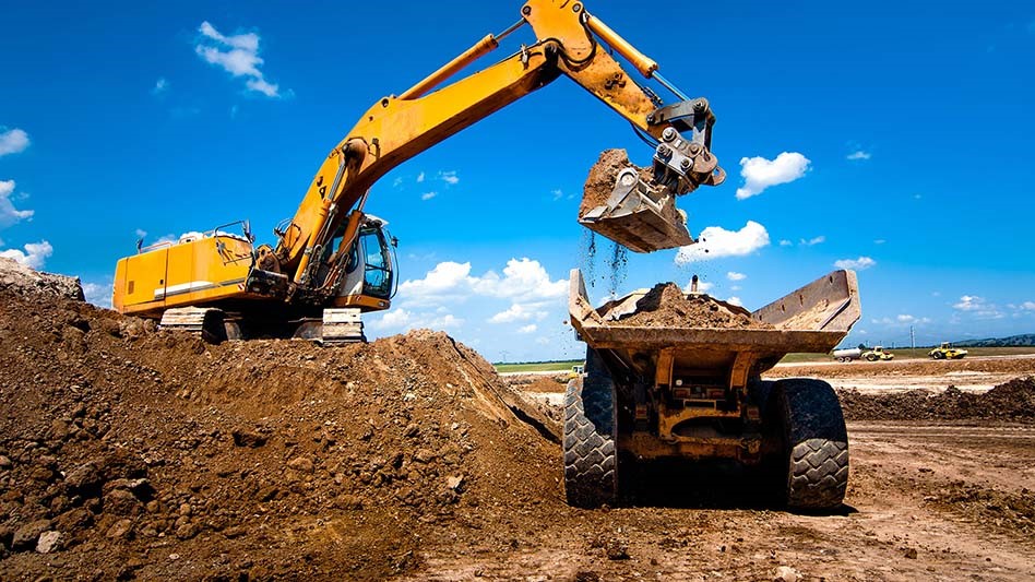 Excavator putting soil in truck