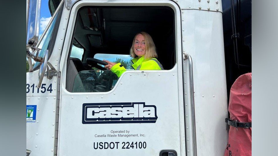 a smiling blonde woman in a truck