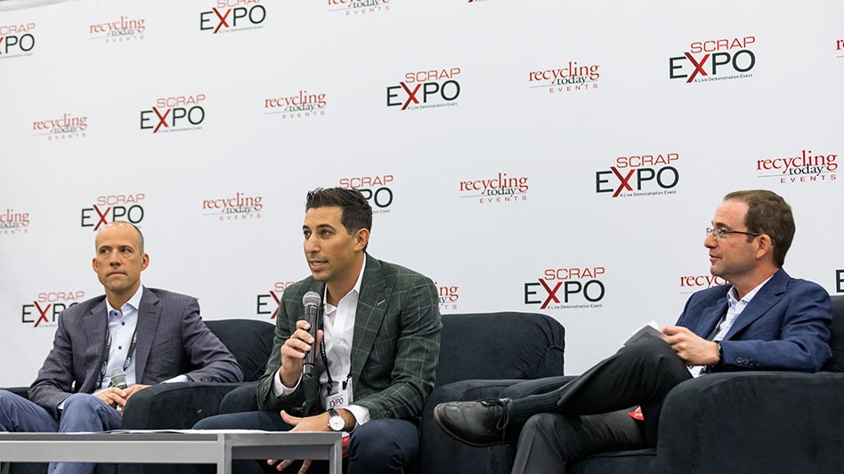 three men seated before a back ground printed with Scrap Expo logo