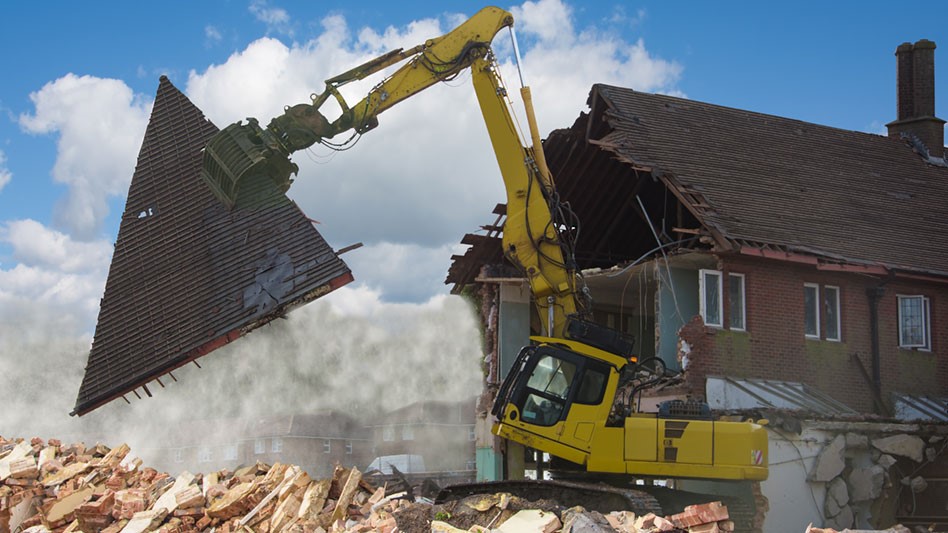 excavator removing roofing