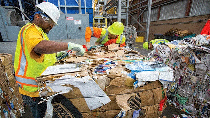 Workers on a bale of OCC