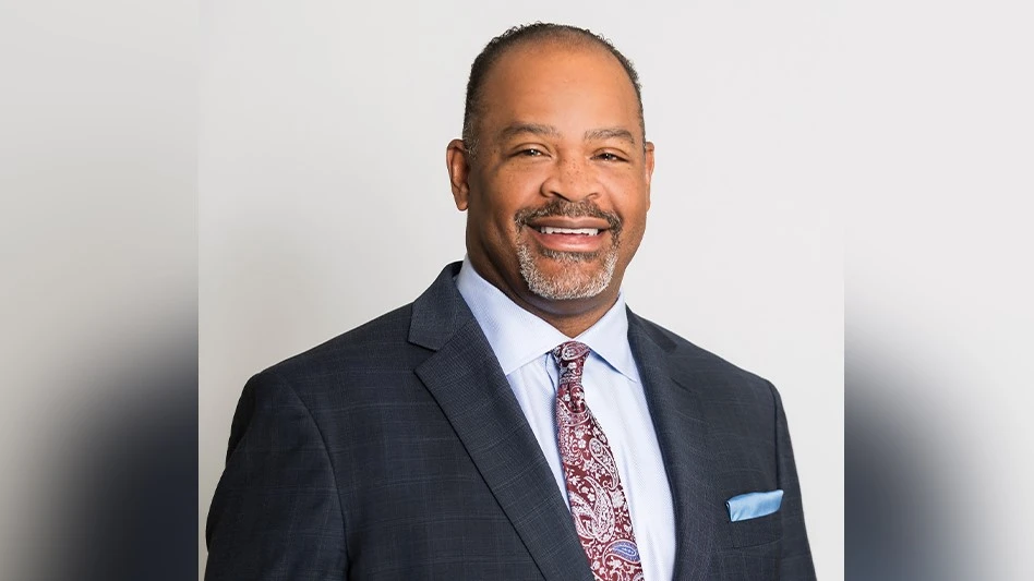 a smiling black man in a suit and tie