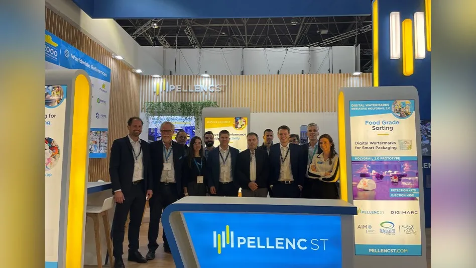 a group of people stand in a trade show booth for Pellenc ST
