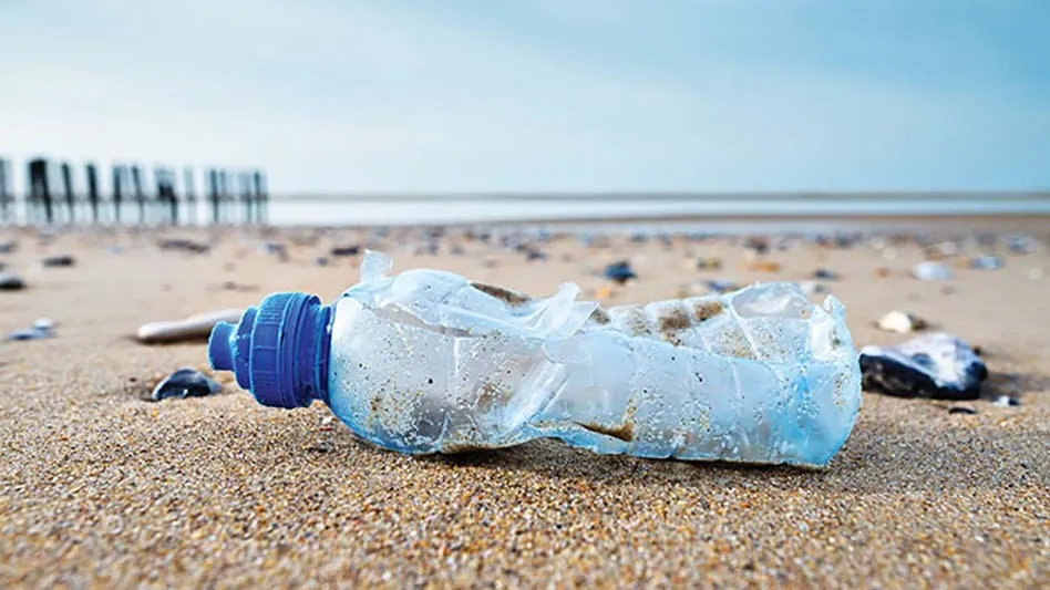 a crushed plastic bottle on a beach