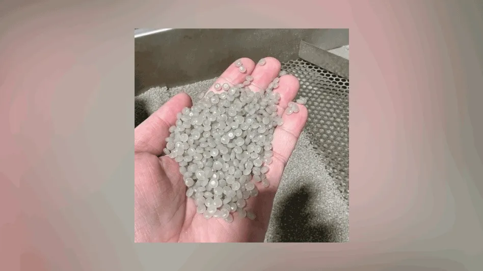 a hand holding plastic pellets