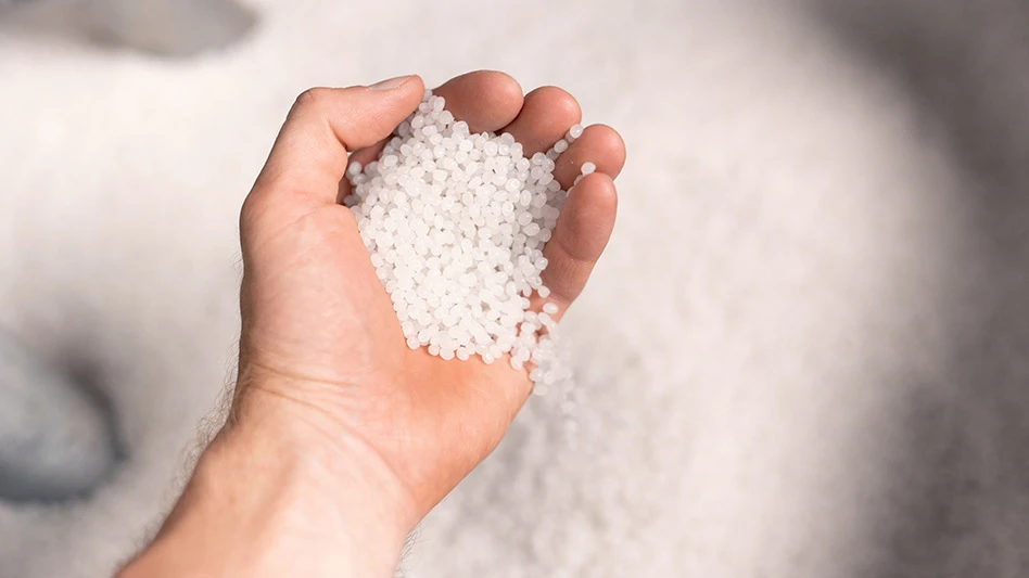 Hand holding recycled plastic pellets