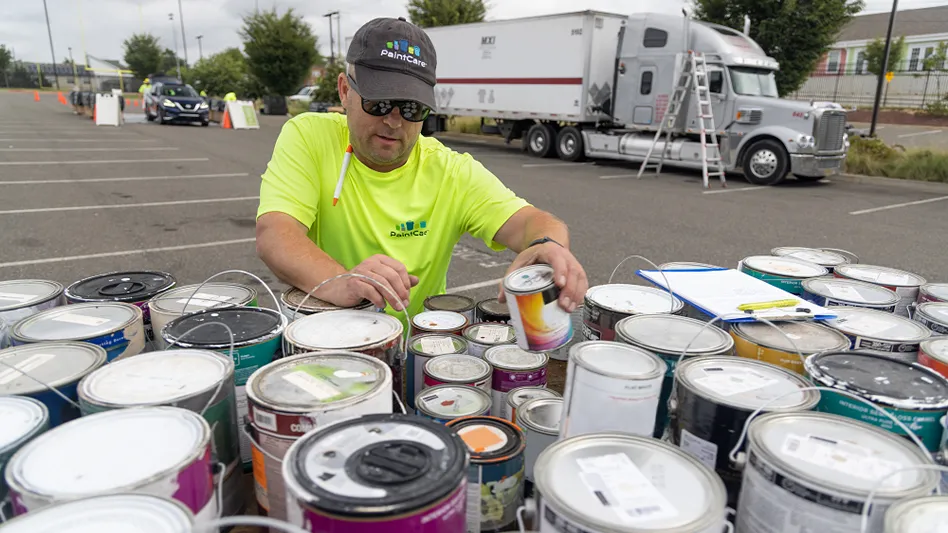 A PaintCare worker in California manages collected paint for recycling.
