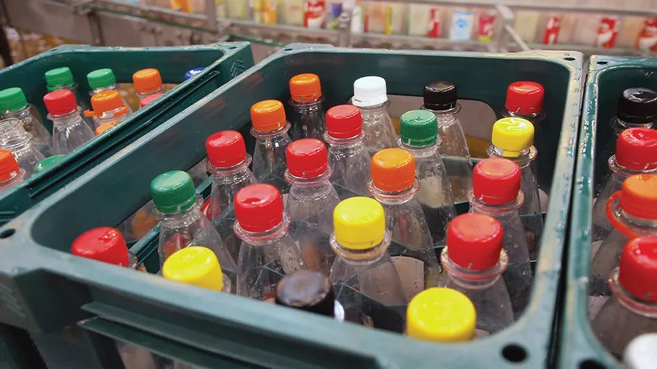 A plastic crate filled with plastic beverage bottles.