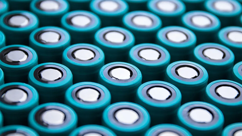 A closeup of rows of lithium-ion batteries with blue tops.