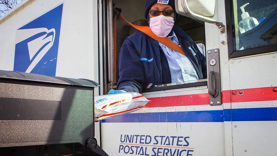 a black lady mail carrier delivers a package from her truck