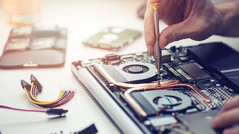 a closeup shot of a person repairing a laptop