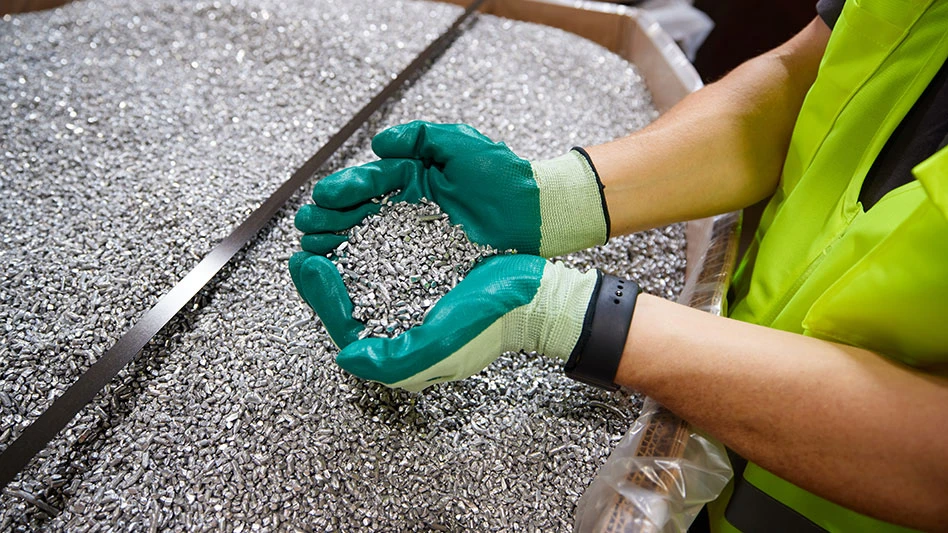 a persons cupped gloved hands hold aluminum chops