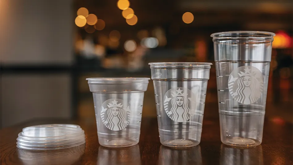 New Starbucks cold cups, made with up to 20 percent less plastic, of various sizes, sit on a table.