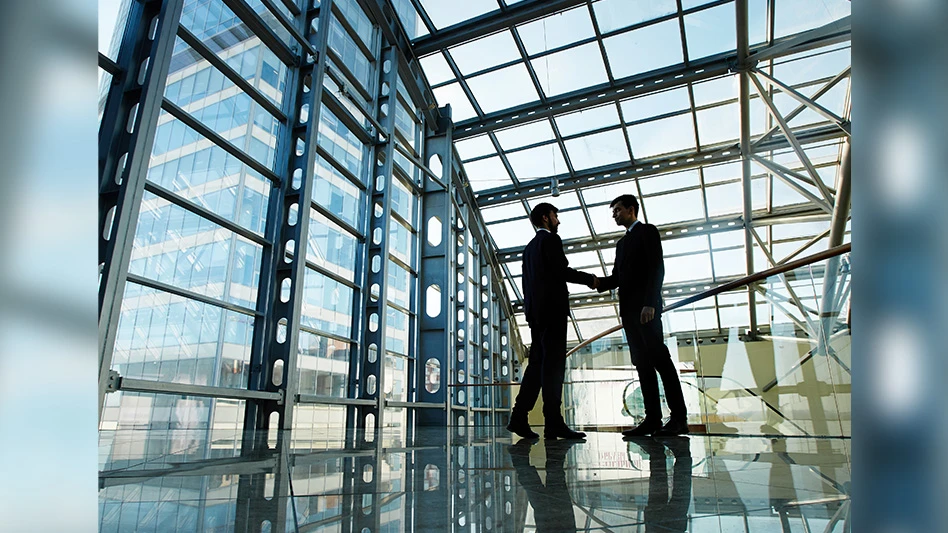 Adobe stock image of two people shaking hands in a business building.