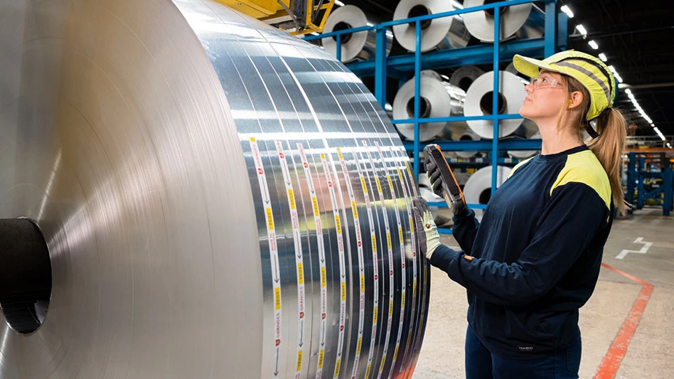 woman inspecting aluminum roll