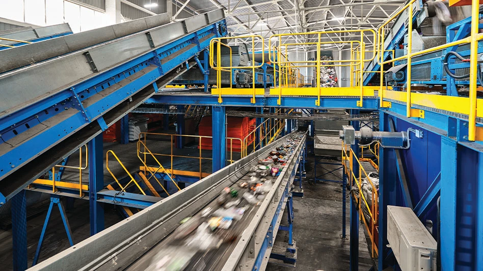 Recyclables move across a conveyor belt at a recycling facility.