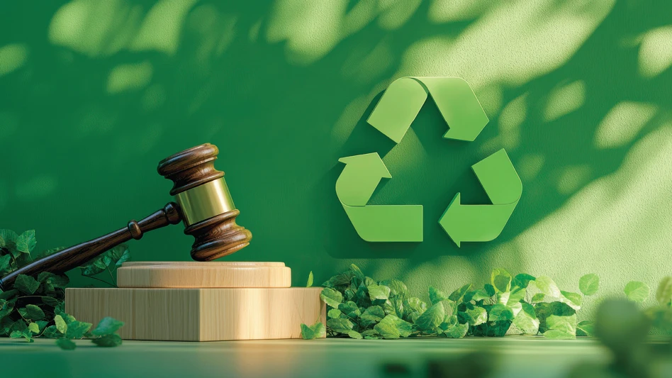 A gavel rests in front of a green recycling symbol.