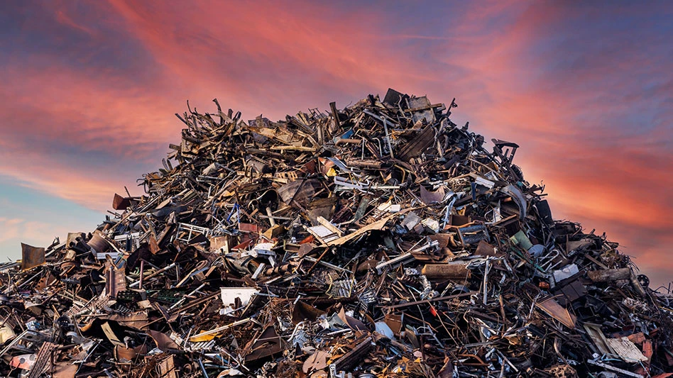 pile of ferrous scrap before a sky at sunset