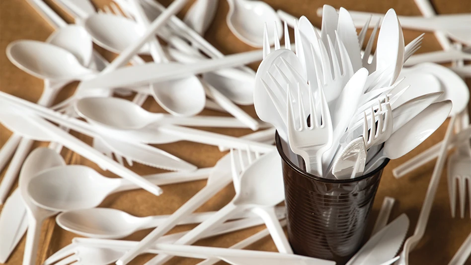 A messy pile of plastic forks, knives and spoons.