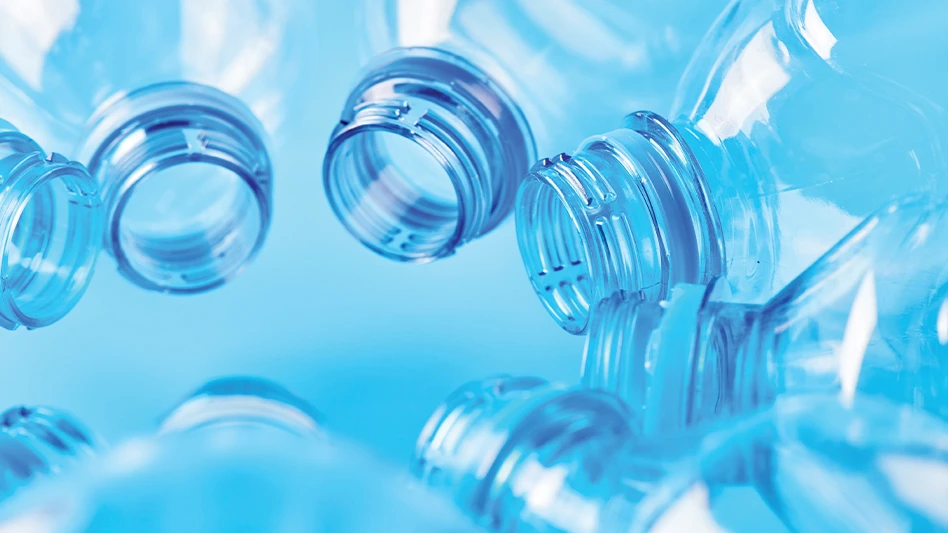 Clear plastic bottles arranged in a circle in front of a blue background.