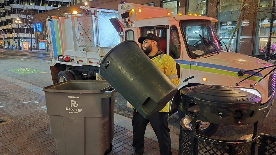 Recology driver Ulises Gonzalez empties public litter can.