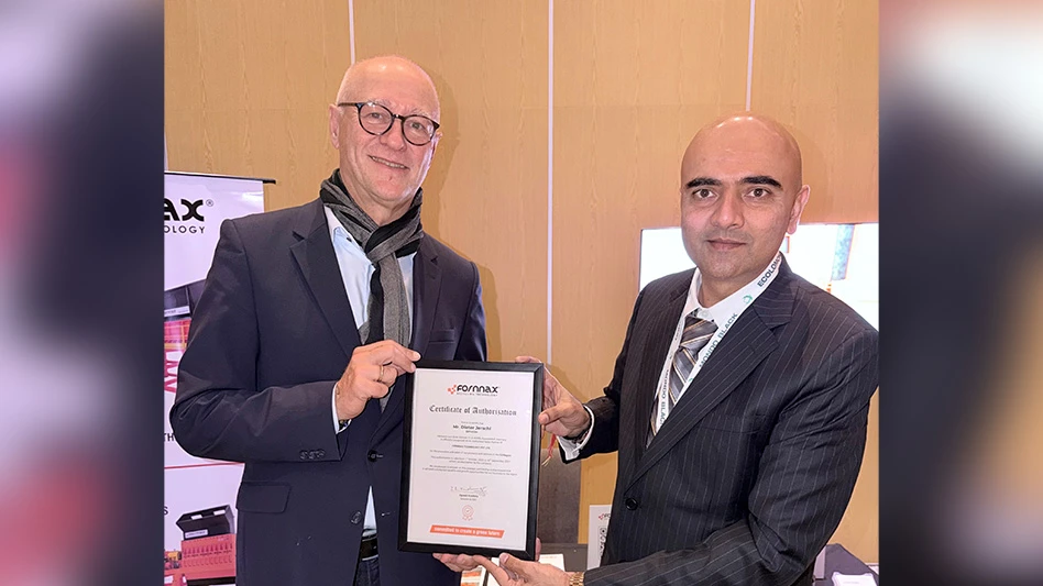 two men smiling holding award