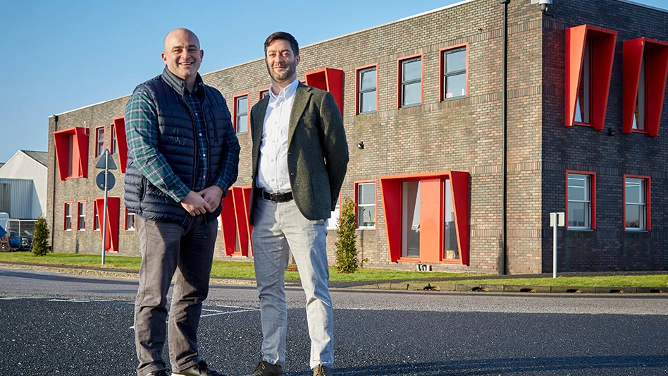 two men stand in front of CPM Crown European office