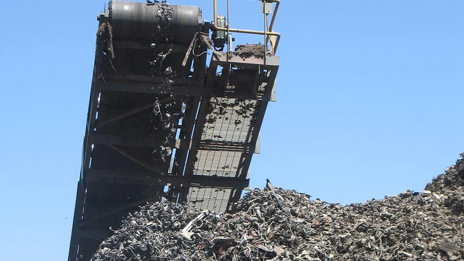 a pile of shredded steel beneath a coveyor belt