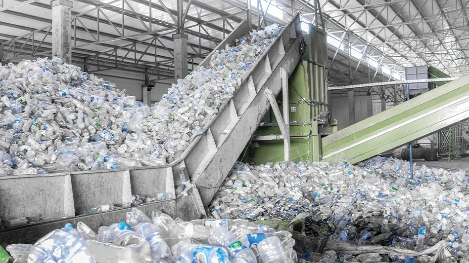 Plastic bottles in containers and on a conveyor belt in a recycling facility.