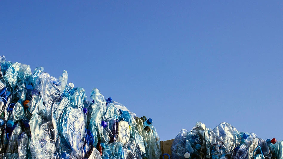 bales of PET bottles for recycling against a blue sky